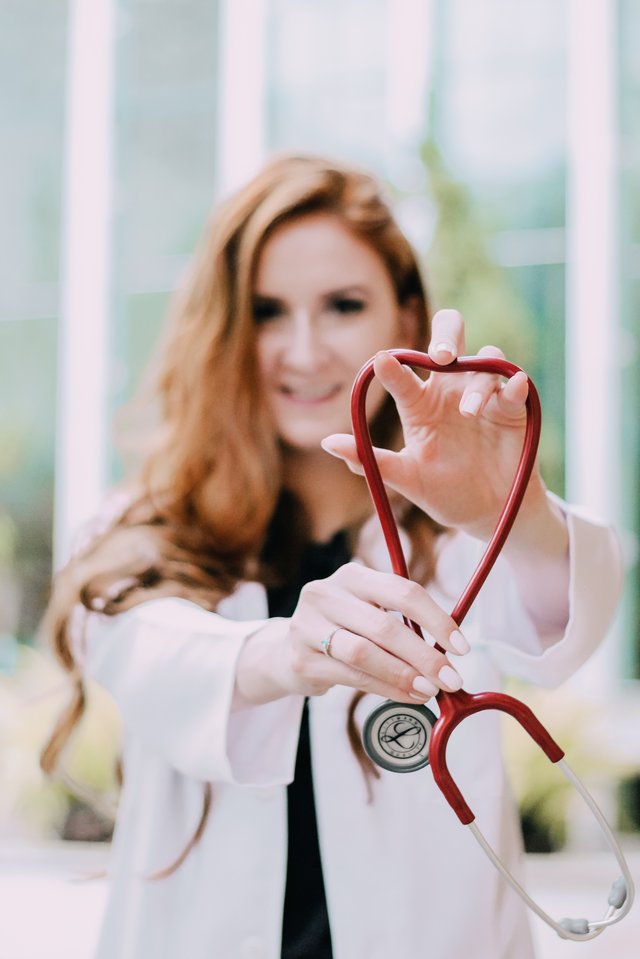 photo-of-woman-holding-red-stethoscope